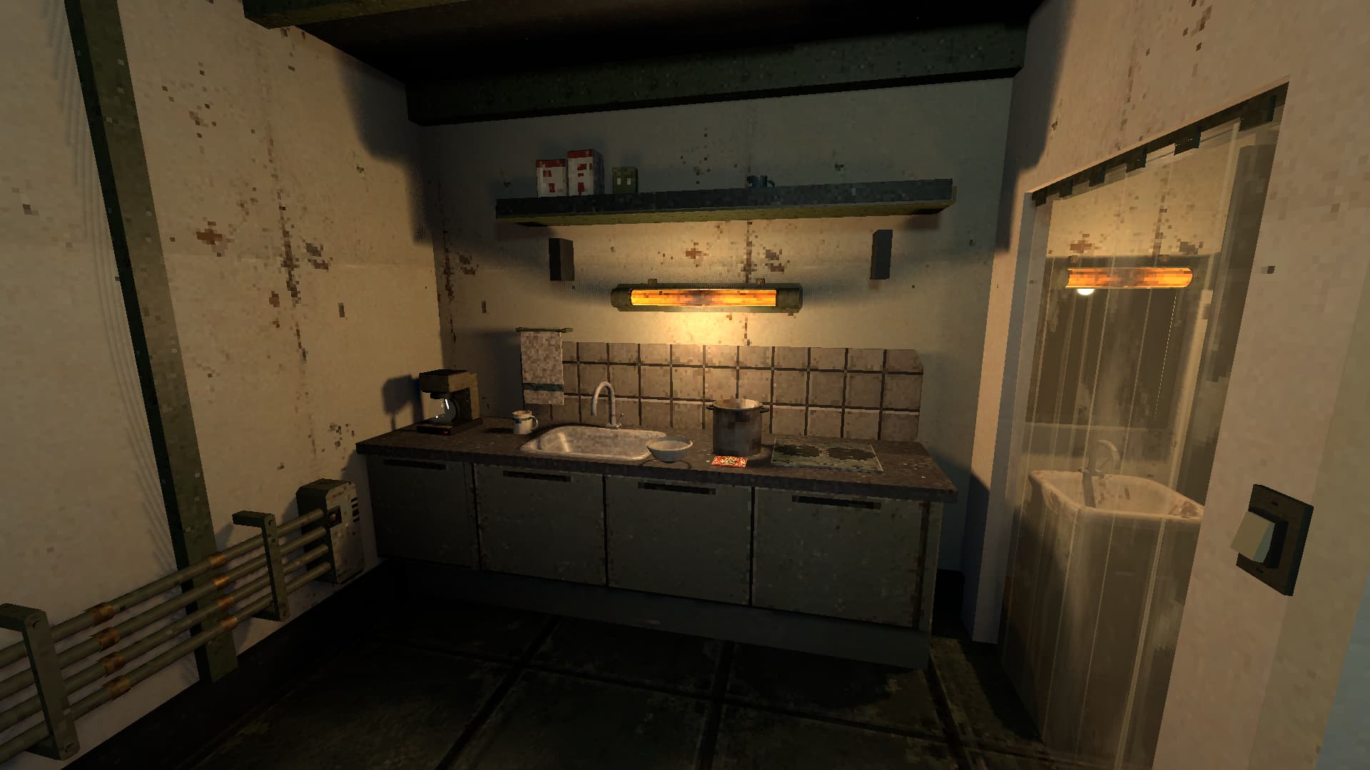 A coffee maker, cooking pot and curtained washroom in the apartment's small kitchen